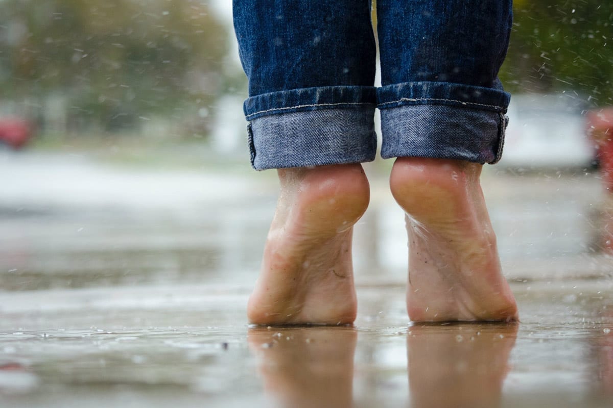Feet standing in the rain